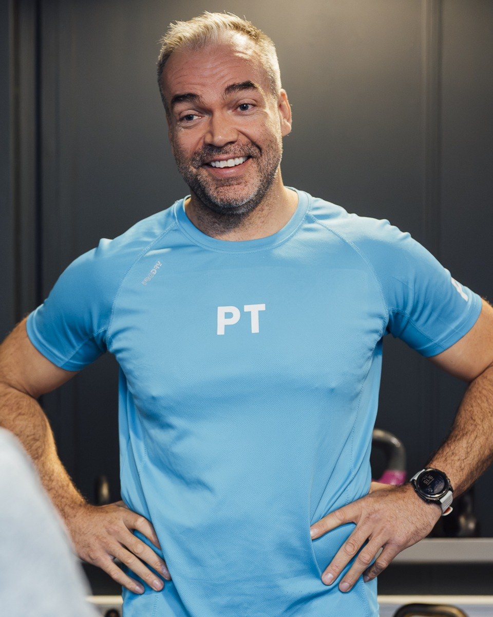 Personlig trener i samtale med en kunde om mål og trening